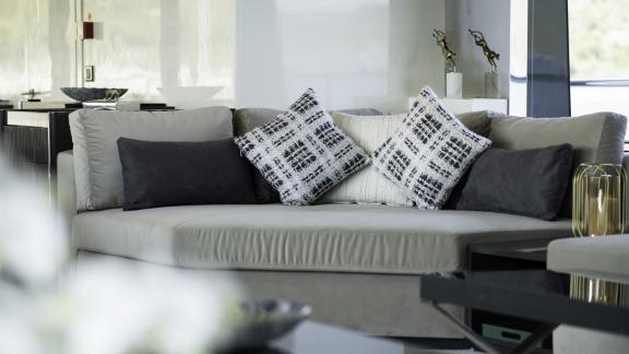 A comfortable couch is decorated with various cushions